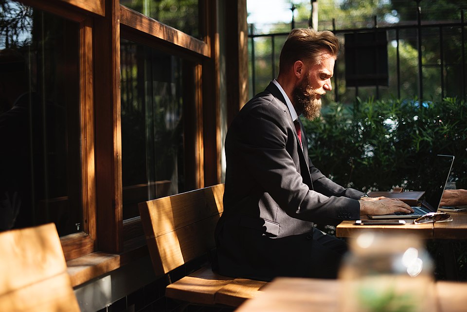A man in suit working on a laptop